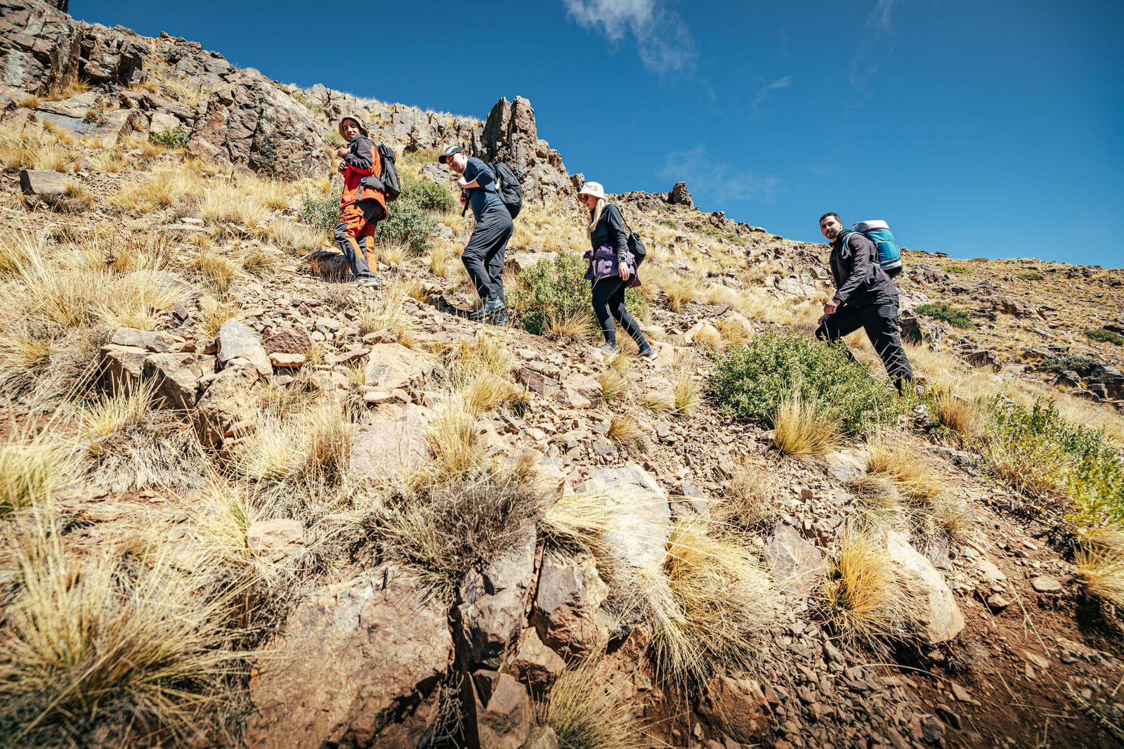 Local mountain guide leading hikers toward Talamrout Summit